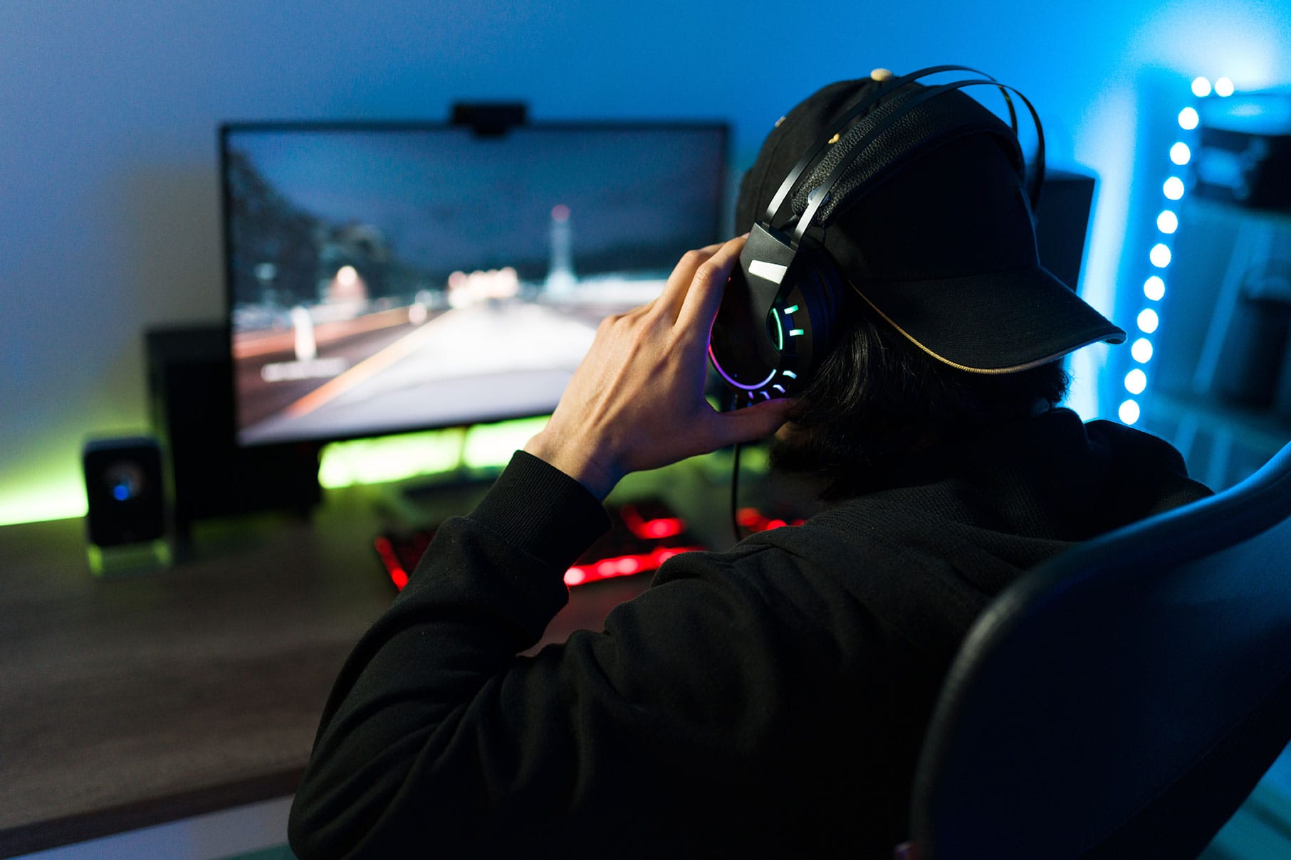 Gamer wearing a headset while playing on a racing simulator