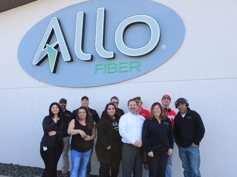 ALLO Scottsbluff employees in front of ALLO sign.