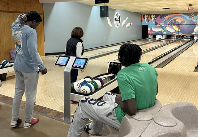 ALLO athlete Malachi Coleman bowling with kids at his Bowling for Brighter Futures event