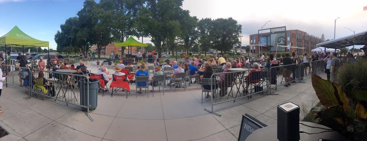 Neighbors gathering for an outdoor ALLO community event
