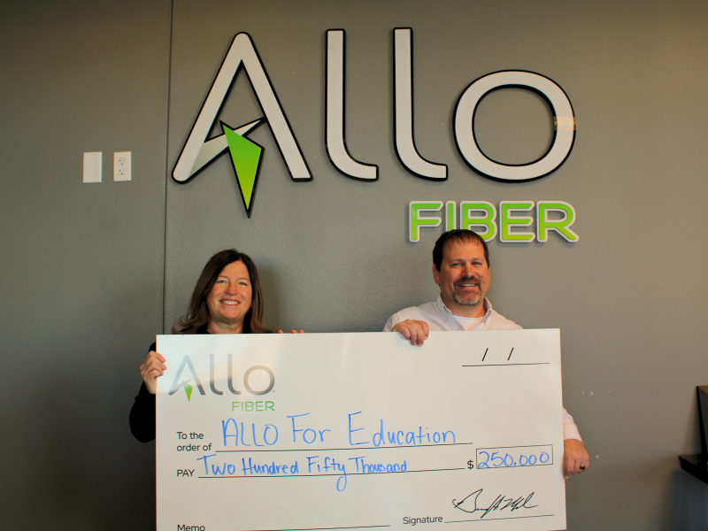 ALLO Fiber Employees holding ALLO for Education check.