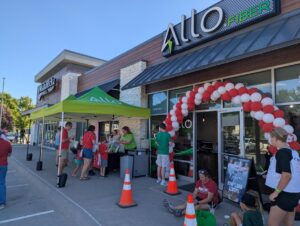 Group standing outside an ALLO store for the Gretna Hoops and Scoops event.